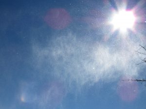 image of snow blowing in the wind and sunlight